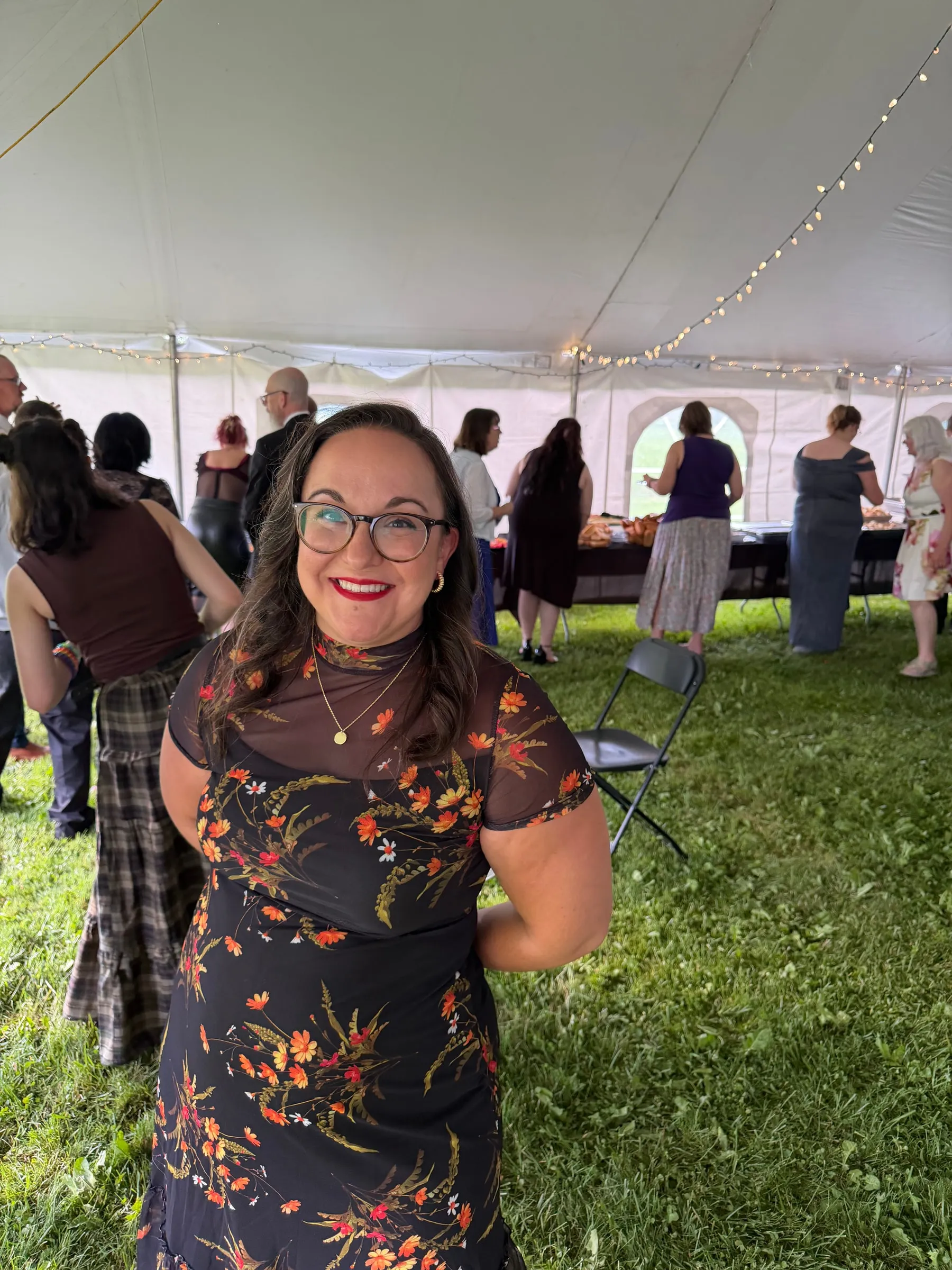 Pastor Ariel smiling at an outdoor gathering.